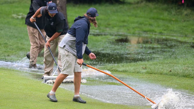 Workers clear the 10th fairway of water during the third round of the 2024 Travelers Championship on June 22, 2024, at TPC River Highlands in Cromwell, CT.